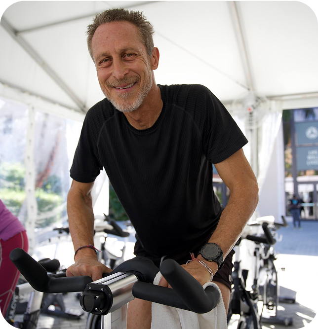 Mark Hyman, MD on a stationary bike taking a SoulCycle class